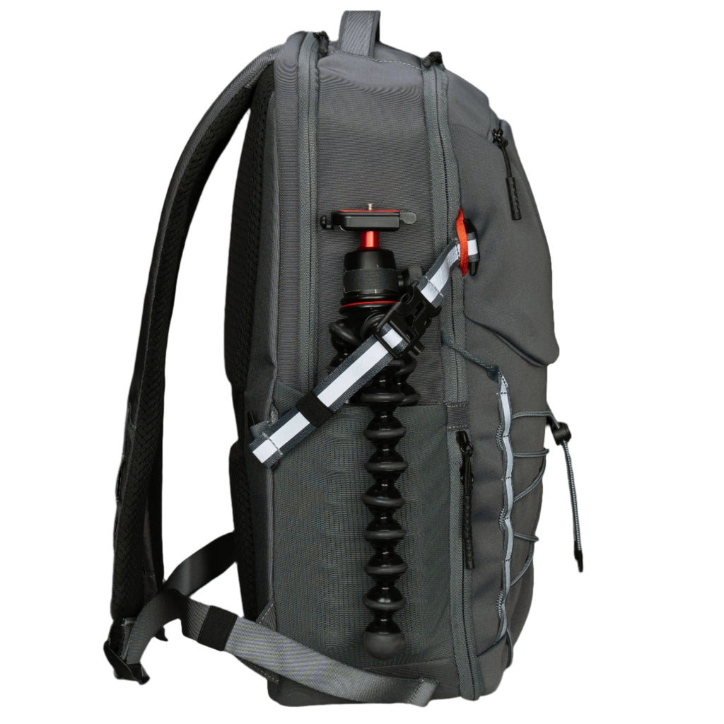 Mochila gris con trípode para cámara fotográfica sobre fondo negro