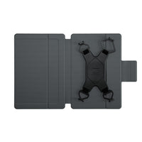 Dispositivo negro con correas sobre un soporte gris sobre un fondo blanco