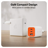 Two compact wall chargers on a wooden surface against a light background. The larger charger on the left is white with an Apple logo, and the smaller charger on the right is white with an orange front panel and visible HYPER branding.